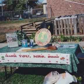 table at Claudell garden with 'Thank You Mrs Simms' banner
